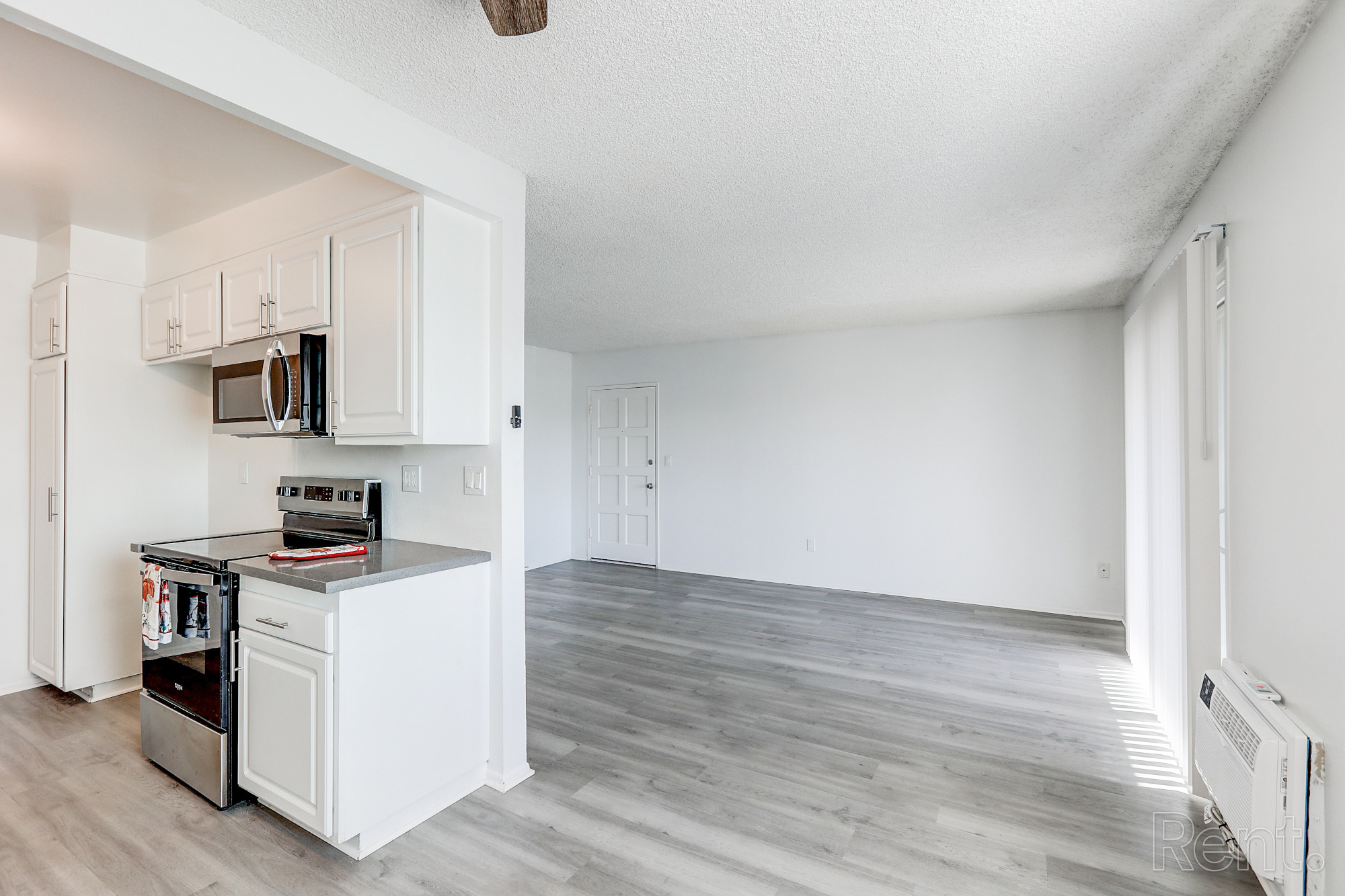 Stylish apartment kitchen with granite countertops, contemporary appliances and stainless steel sink