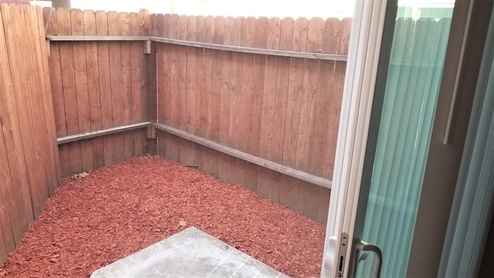 Personal fenced in patio with mulch floor