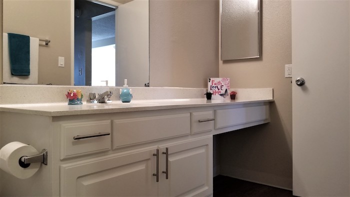 Bathroom vanity with cabinets and granite counter top
